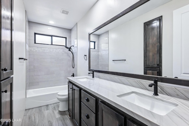 4801 N Diana Ave, Lake Havasu City, AZ 86404 - full bathroom featuring toilet, double vanity, and tub / shower combination