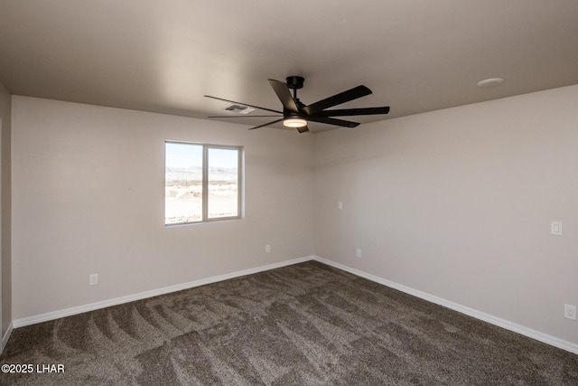 empty room with ceiling fan and dark colored carpet