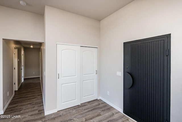 unfurnished bedroom with a closet and hardwood / wood-style flooring