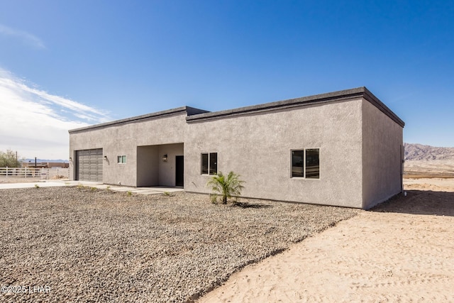 rear view of property featuring a garage