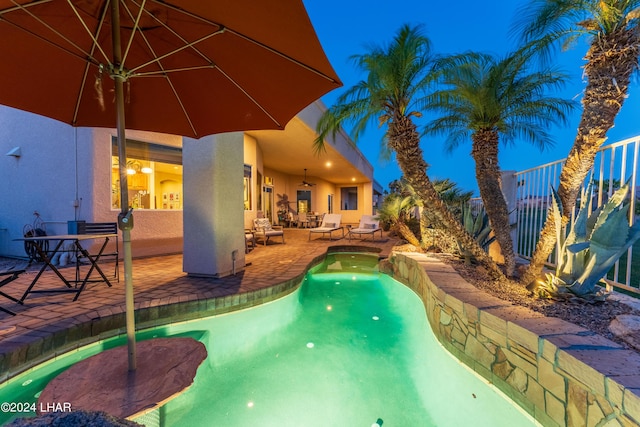 view of pool with a patio area and ceiling fan