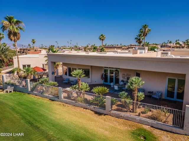 back of property featuring a yard and a patio area