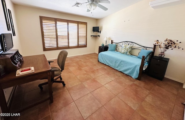 bedroom with ceiling fan, baseboards, and light tile patterned floors