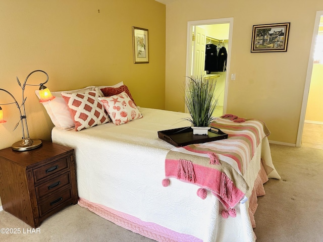 bedroom featuring light colored carpet and baseboards