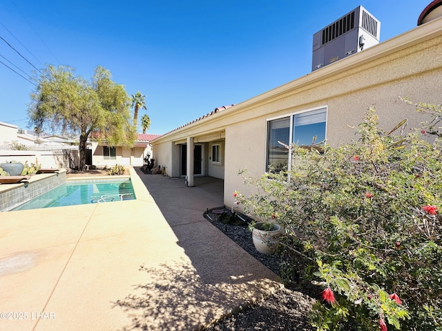 view of swimming pool with a fenced in pool, a patio area, fence, and central AC unit