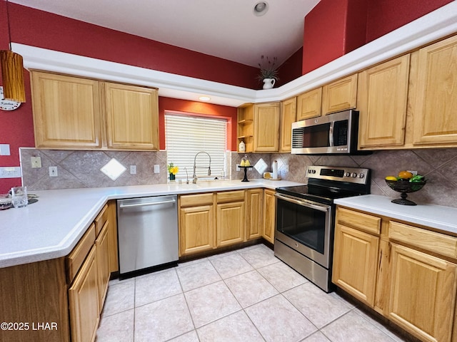 kitchen with light tile patterned floors, a sink, light countertops, appliances with stainless steel finishes, and backsplash