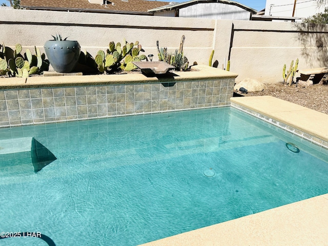 view of swimming pool with fence