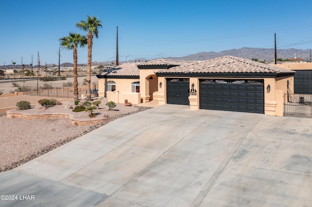 view of front facade with a garage and a mountain view