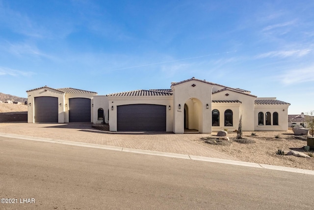 mediterranean / spanish house featuring a garage