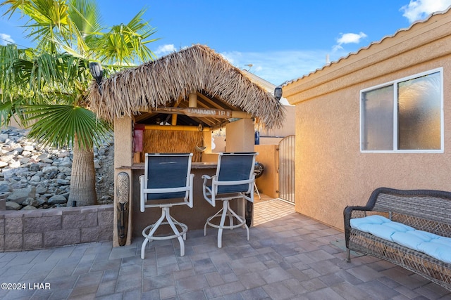 view of patio with a gazebo and outdoor dry bar