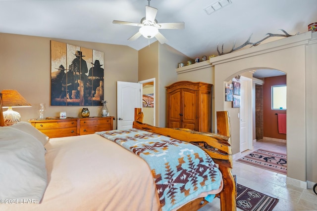 bedroom featuring visible vents, ceiling fan, baseboards, lofted ceiling, and arched walkways