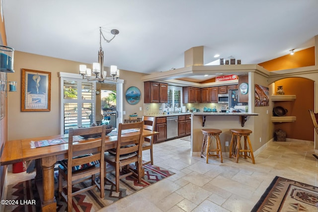 dining room featuring stone tile floors, baseboards, lofted ceiling, arched walkways, and a notable chandelier