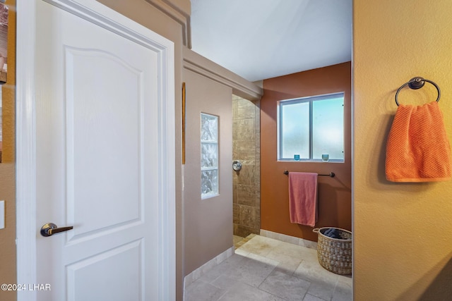 full bathroom with baseboards and a walk in shower