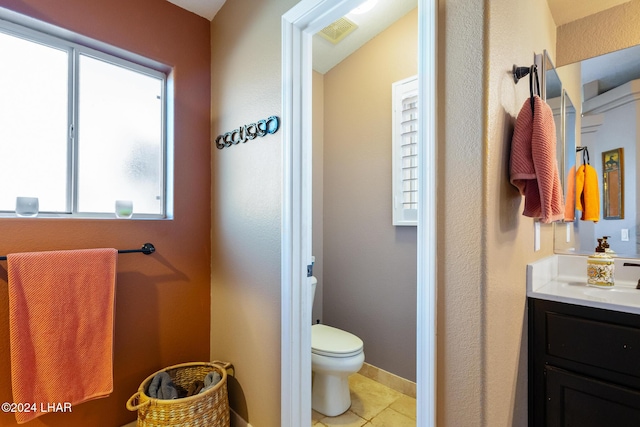 bathroom featuring visible vents, toilet, vanity, and tile patterned flooring