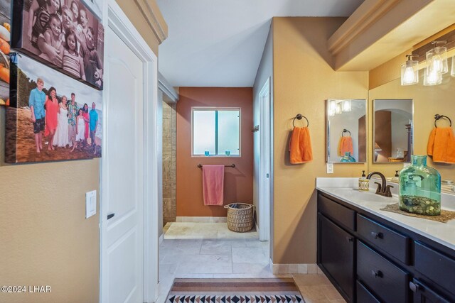 bathroom featuring a sink, baseboards, and double vanity