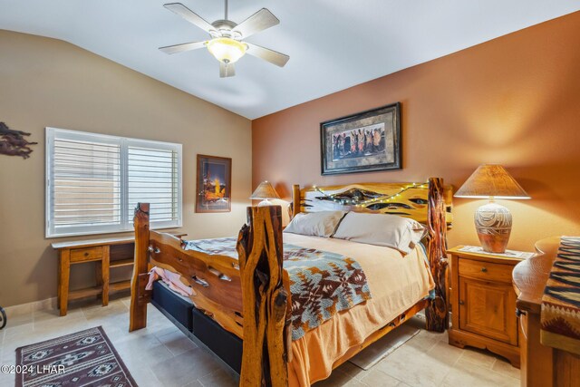 bedroom with ceiling fan, baseboards, and lofted ceiling