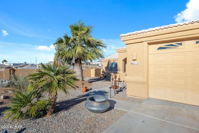 exterior space featuring a garage and fence