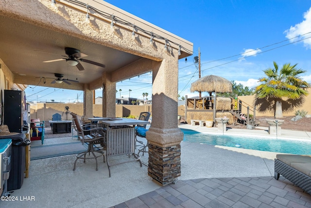 view of patio / terrace with outdoor dining space, a fenced in pool, an outdoor fire pit, and a fenced backyard