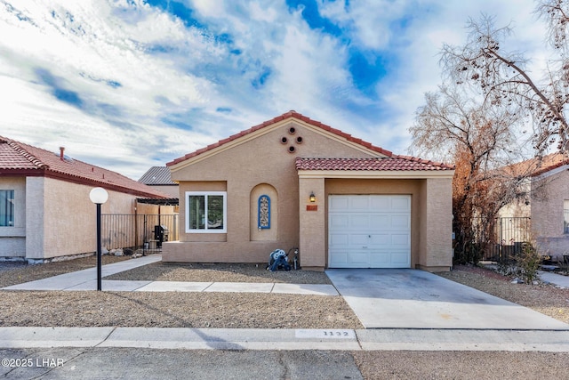 mediterranean / spanish-style house with a garage