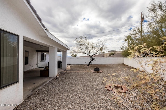 view of yard featuring an outdoor fire pit and a patio area