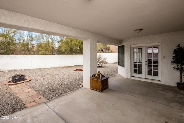 view of patio with french doors and an outdoor fire pit