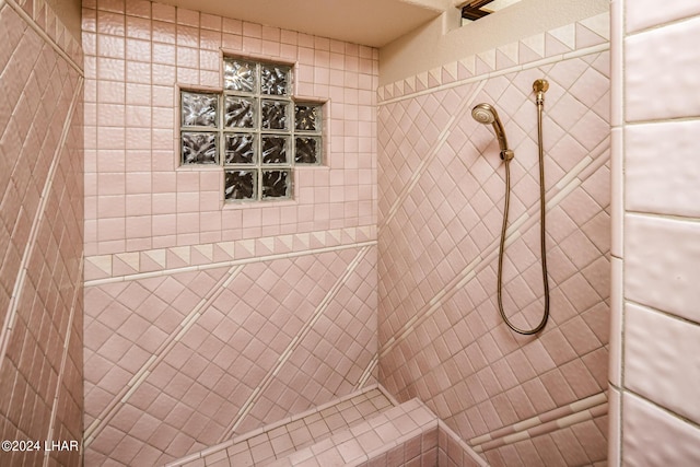 bathroom with a tile shower