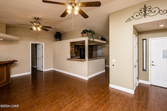 unfurnished living room with ceiling fan, lofted ceiling, and dark hardwood / wood-style flooring