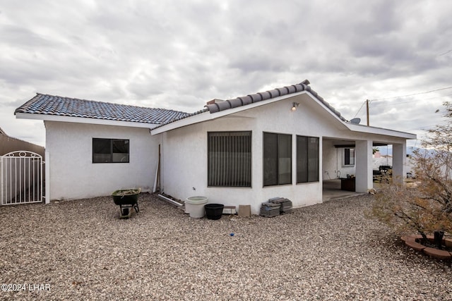 back of house with a patio