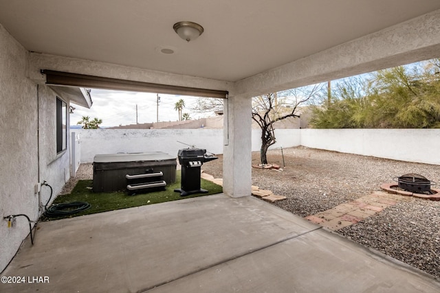 view of patio featuring a fire pit and a hot tub