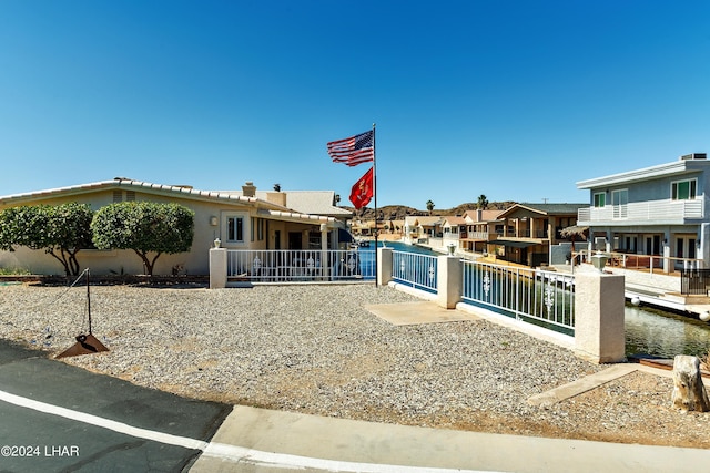 view of front of house with a water view
