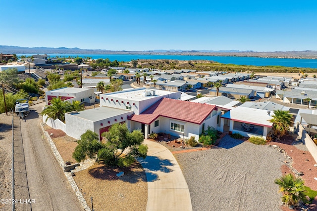 drone / aerial view featuring a water and mountain view