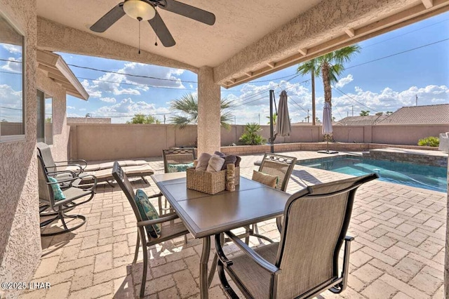 view of patio / terrace featuring outdoor dining area, a fenced backyard, ceiling fan, and a fenced in pool