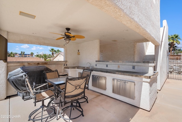1901 Gold Dust Dr, Lake Havasu City, AZ 86404 - view of patio with an outdoor kitchen, a ceiling fan, outdoor dining area, a sink, and fence