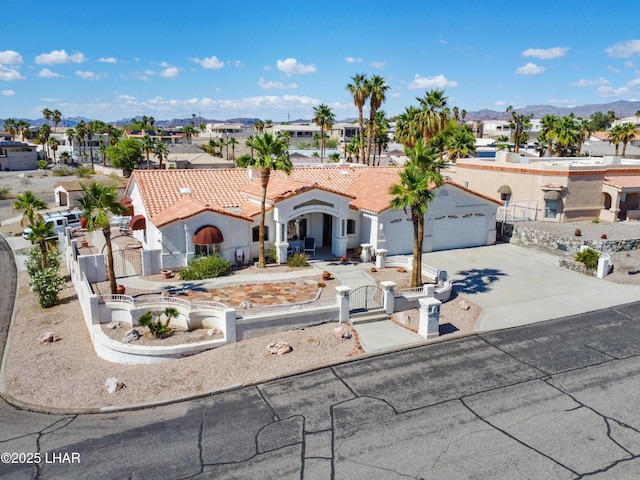 1901 Gold Dust Dr, Lake Havasu City, AZ 86404 - mediterranean / spanish-style house featuring a fenced front yard, a gate, a residential view, concrete driveway, and stucco siding