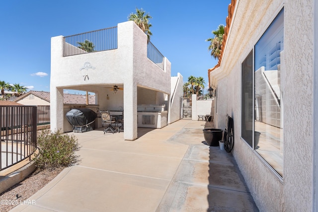 1901 Gold Dust Dr, Lake Havasu City, AZ 86404 - view of patio / terrace featuring exterior kitchen, a fenced backyard, ceiling fan, and a balcony