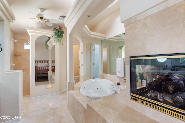 1901 Gold Dust Dr, Lake Havasu City, AZ 86404 - full bath featuring ceiling fan, a tub with jets, toilet, a multi sided fireplace, and tile patterned floors