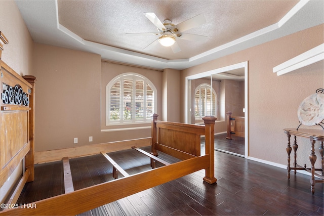 1901 Gold Dust Dr, Lake Havasu City, AZ 86404 - bedroom with a raised ceiling, wood finished floors, a textured ceiling, a closet, and baseboards