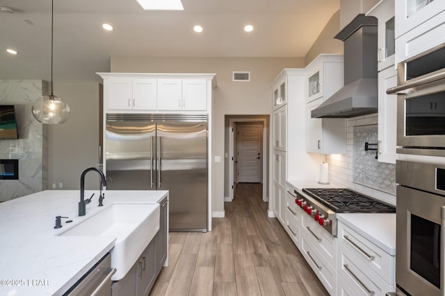 2008 Martinique Dr, Lake Havasu City, AZ 86406 - kitchen with wall chimney range hood, appliances with stainless steel finishes, decorative backsplash, white cabinets, and recessed lighting