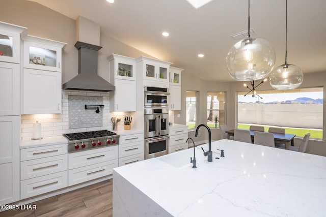 2008 Martinique Dr, Lake Havasu City, AZ 86406 - kitchen with stainless steel appliances, wall chimney exhaust hood, recessed lighting, tasteful backsplash, and white cabinetry