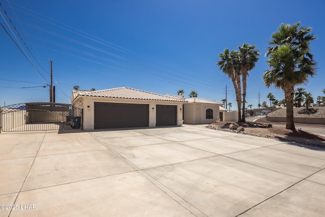 2008 Martinique Dr, Lake Havasu City, AZ 86406 - mediterranean / spanish house featuring a gate, stucco siding, a tiled roof, driveway, and a garage