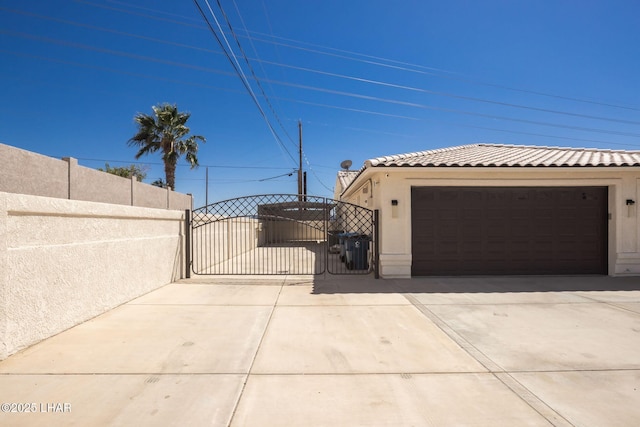 2008 Martinique Dr, Lake Havasu City, AZ 86406 - view of side of property with a gate, a tiled roof, and stucco siding