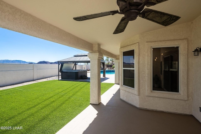 2008 Martinique Dr, Lake Havasu City, AZ 86406 - fenced backyard featuring a gazebo, a patio, ceiling fan, and a mountain view