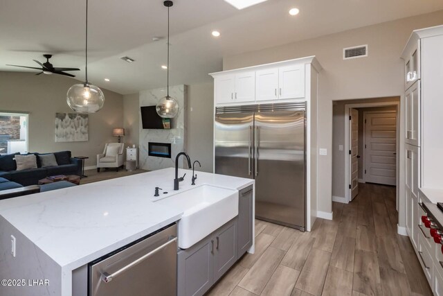2008 Martinique Dr, Lake Havasu City, AZ 86406 - kitchen with appliances with stainless steel finishes, open floor plan, a fireplace, a ceiling fan, and recessed lighting
