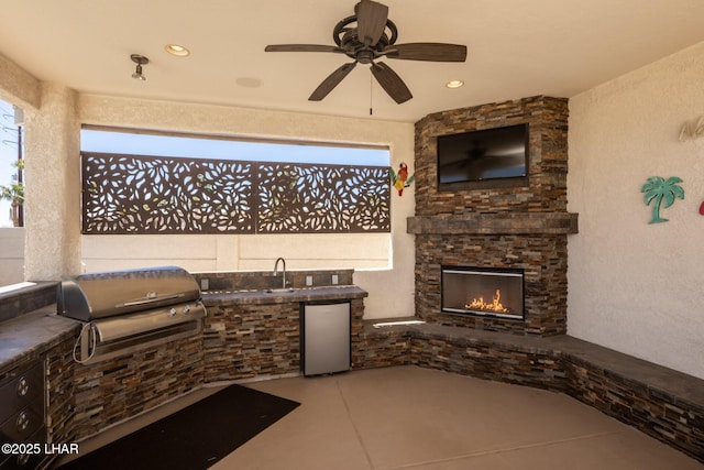 2008 Martinique Dr, Lake Havasu City, AZ 86406 - view of patio with a fireplace, an outdoor kitchen, and a ceiling fan