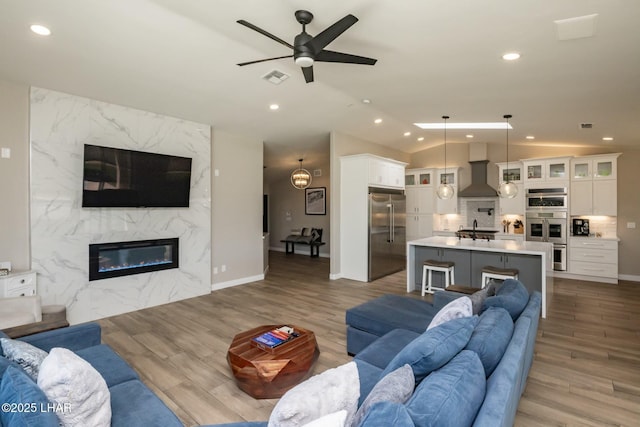 2008 Martinique Dr, Lake Havasu City, AZ 86406 - living room with recessed lighting, a ceiling fan, wood finished floors, vaulted ceiling, and a fireplace