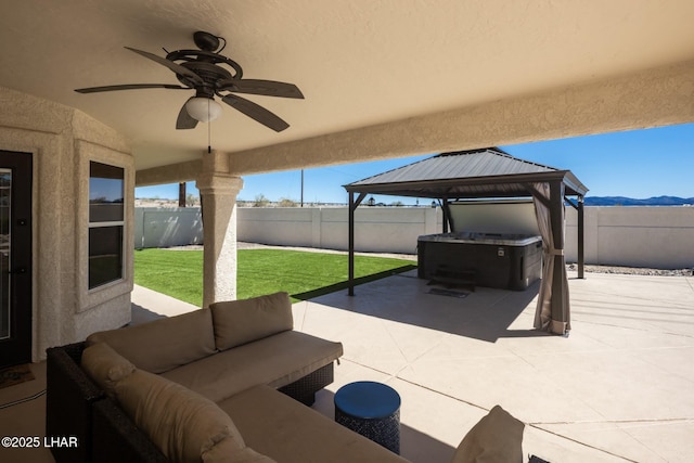 2008 Martinique Dr, Lake Havasu City, AZ 86406 - fenced backyard featuring an outdoor hangout area, a patio area, a gazebo, a ceiling fan, and a mountain view