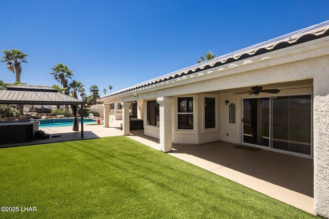 2008 Martinique Dr, Lake Havasu City, AZ 86406 - view of green lawn with a gazebo, a patio, an outdoor pool, and a ceiling fan