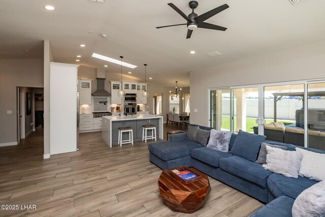 2008 Martinique Dr, Lake Havasu City, AZ 86406 - living room with light wood-type flooring, a ceiling fan, recessed lighting, a chandelier, and lofted ceiling