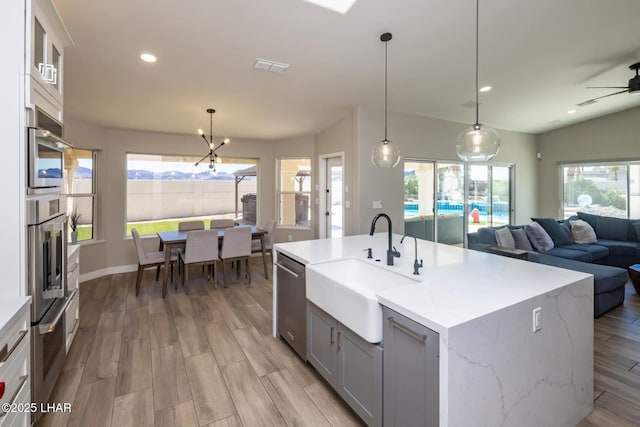 2008 Martinique Dr, Lake Havasu City, AZ 86406 - kitchen featuring stainless steel dishwasher, open floor plan, light wood-type flooring, recessed lighting, and hanging light fixtures