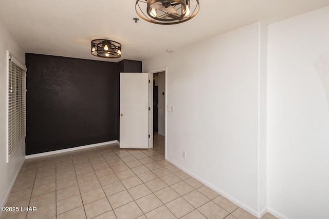 2230 Havasupai Blvd, Lake Havasu City, AZ 86403 - spare room with light tile patterned floors, a chandelier, fire sprinkler in ceiling, and baseboards